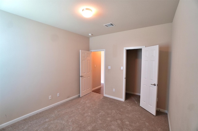 unfurnished bedroom featuring light colored carpet