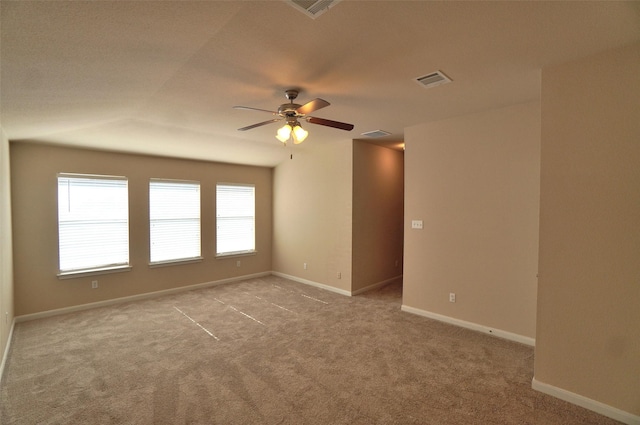 empty room featuring ceiling fan and light carpet