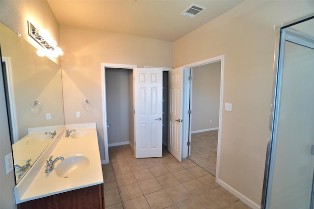 bathroom featuring tile patterned flooring and vanity