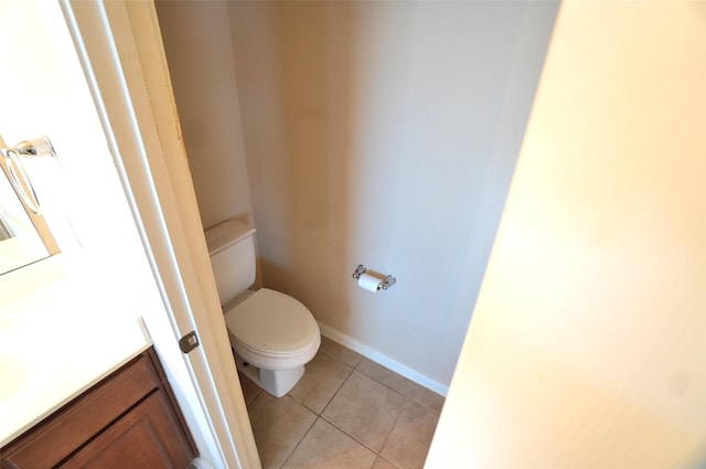 bathroom with tile patterned flooring, vanity, and toilet