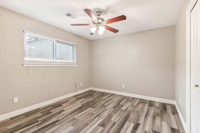 spare room featuring wood-type flooring