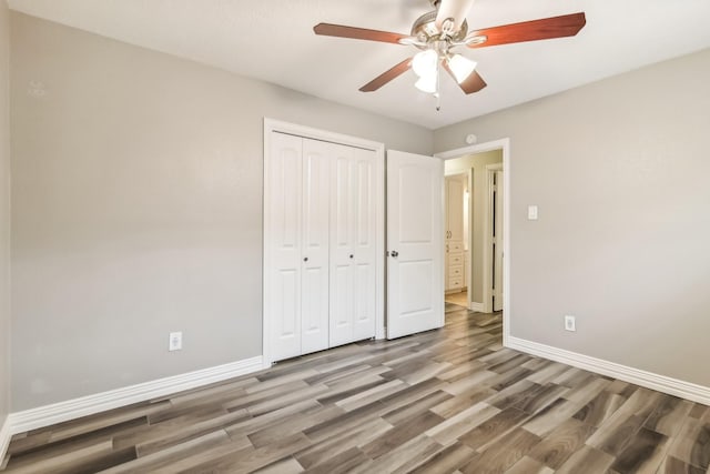 unfurnished bedroom featuring ceiling fan, light hardwood / wood-style floors, and a closet