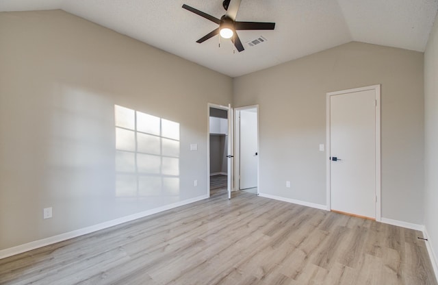 unfurnished room featuring ceiling fan, light wood-type flooring, and vaulted ceiling