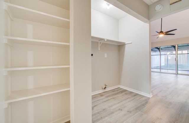 washroom with hookup for an electric dryer, light wood-type flooring, and ceiling fan