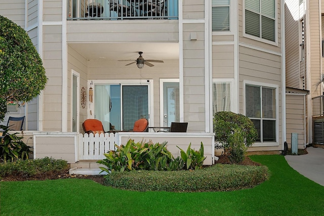 doorway to property with a balcony and ceiling fan