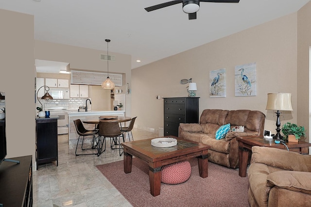 living room featuring ceiling fan and sink