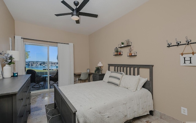 bedroom with ceiling fan, a water view, and access to outside