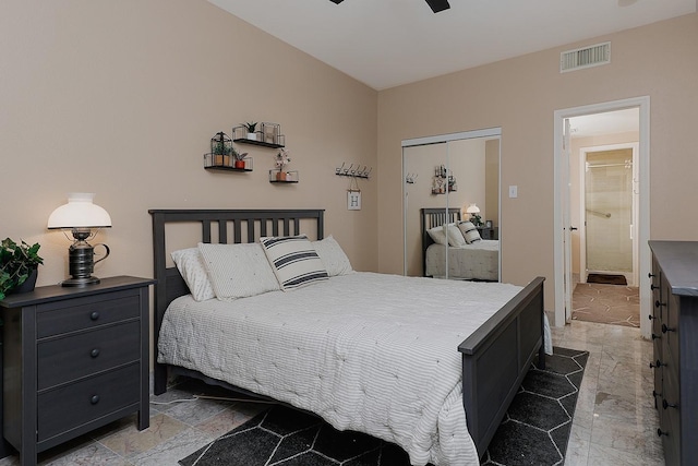 bedroom featuring ceiling fan, ensuite bath, and a closet