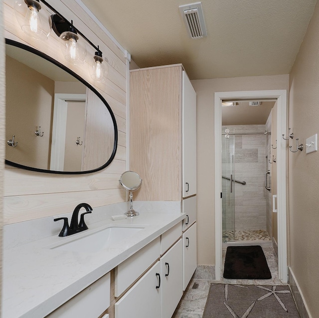 bathroom featuring tile patterned flooring, vanity, and an enclosed shower