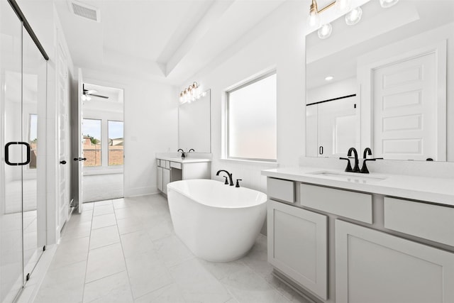 bathroom featuring vanity, ceiling fan, a raised ceiling, and plus walk in shower