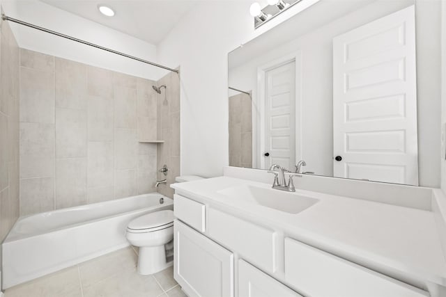 full bathroom featuring toilet, vanity, tile patterned floors, and tiled shower / bath