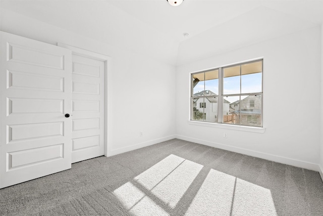 unfurnished bedroom featuring light colored carpet and a closet