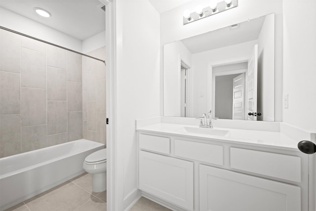 full bathroom featuring tile patterned flooring, vanity, tiled shower / bath combo, and toilet