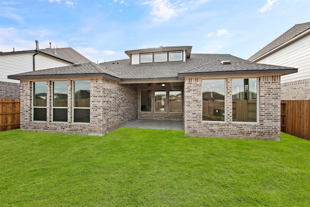 back of property featuring a yard and a patio area