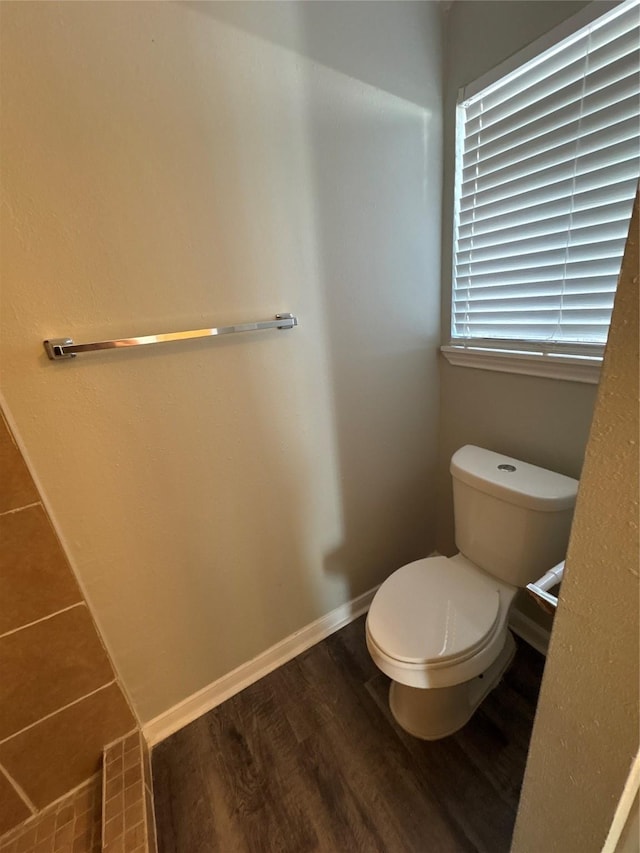 bathroom with hardwood / wood-style floors and toilet