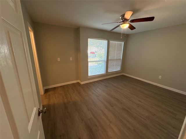 spare room featuring dark hardwood / wood-style floors and ceiling fan