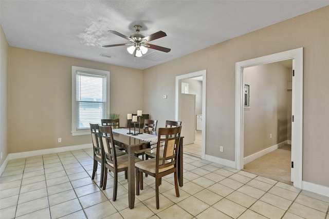 dining space with ceiling fan, light tile patterned floors, and a textured ceiling