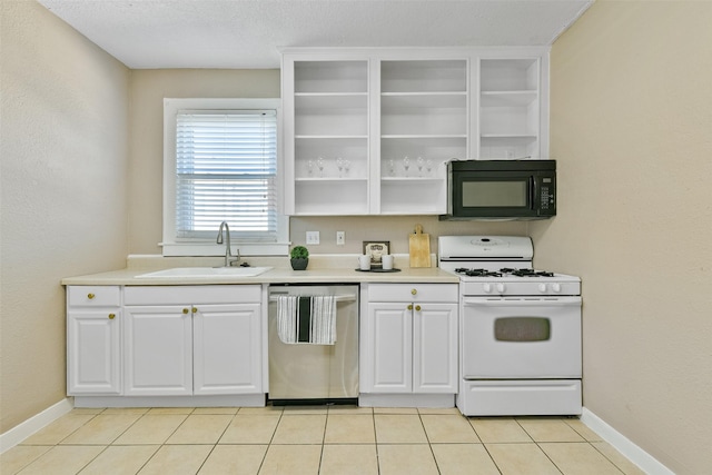 kitchen with dishwasher, sink, white gas range, light tile patterned floors, and white cabinetry