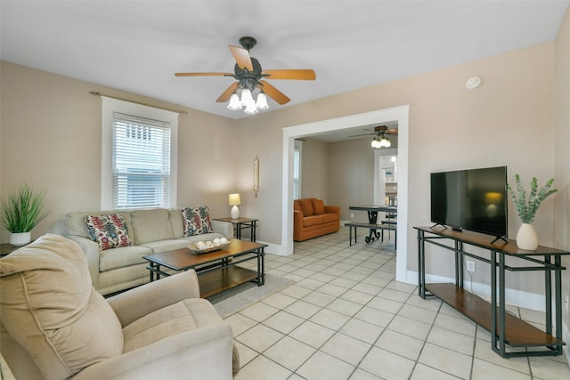 living room with ceiling fan and light tile patterned flooring