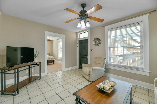 living room with light tile patterned floors and ceiling fan