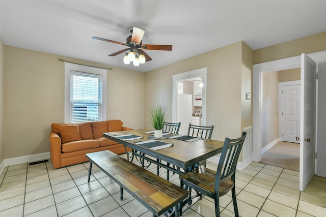 tiled dining space featuring ceiling fan