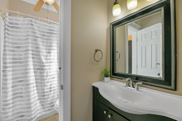 bathroom featuring ceiling fan, vanity, and toilet