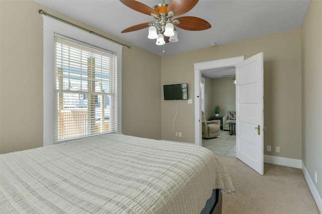 bedroom featuring ceiling fan and light colored carpet