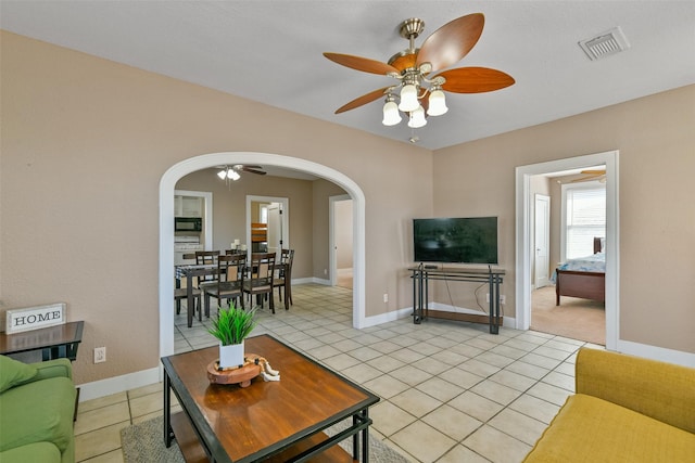 tiled living room featuring ceiling fan