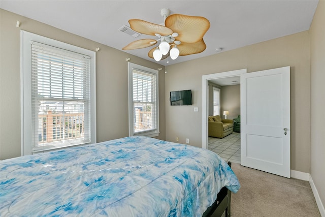 carpeted bedroom with multiple windows and ceiling fan