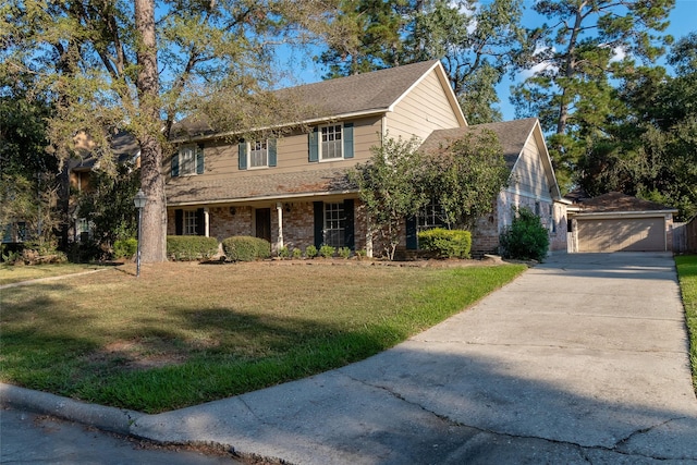 view of front of home featuring an outbuilding, a front yard, and a garage