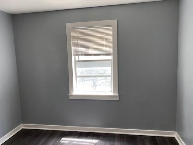 spare room featuring dark hardwood / wood-style flooring