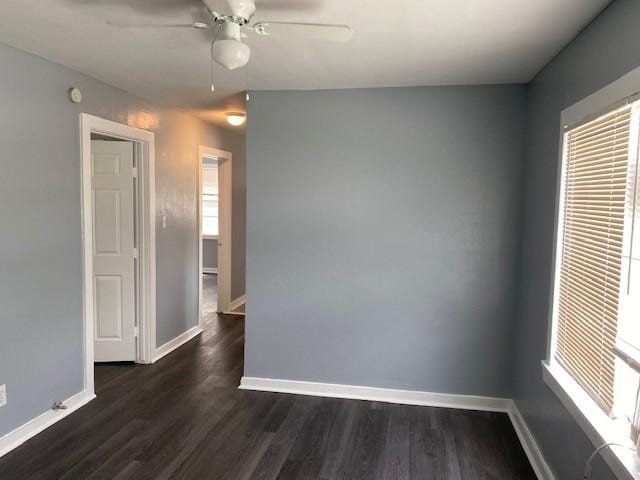 unfurnished room with ceiling fan and dark wood-type flooring