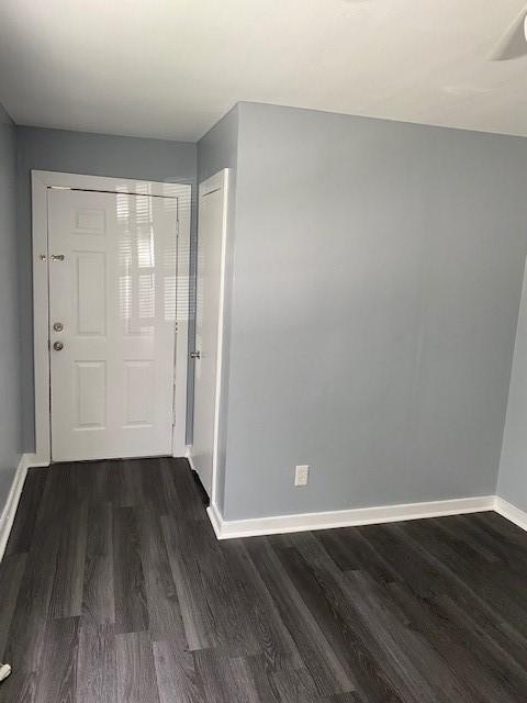 hallway featuring dark wood-type flooring