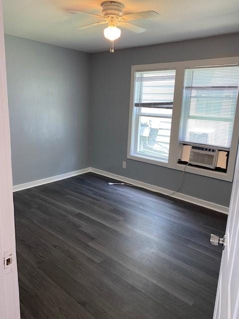 unfurnished room with ceiling fan, cooling unit, and dark hardwood / wood-style flooring