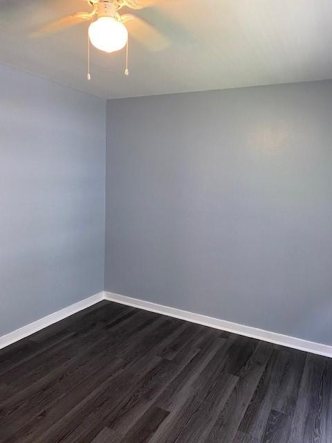 spare room featuring dark hardwood / wood-style floors and ceiling fan