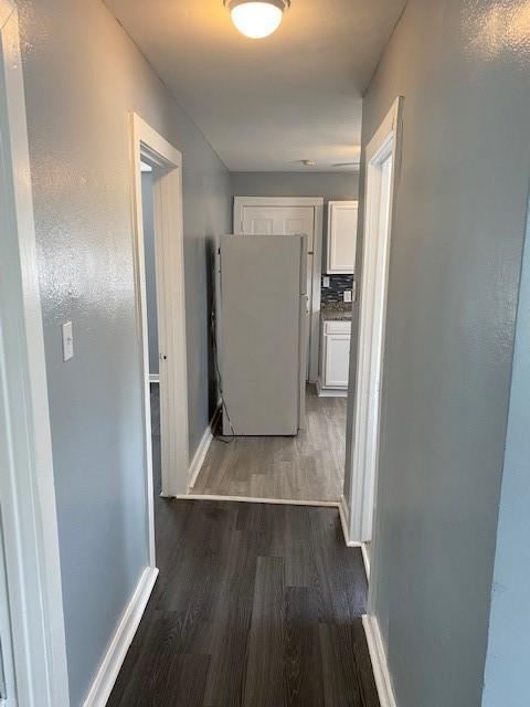 hall with dark wood-type flooring