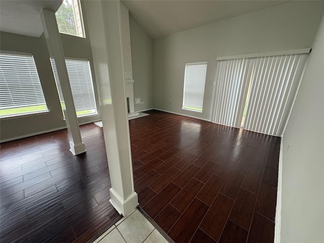 spare room with hardwood / wood-style floors and a towering ceiling