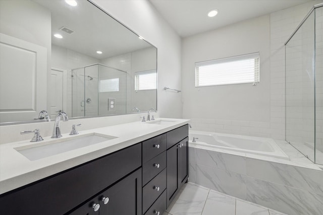 bathroom with shower with separate bathtub and vanity