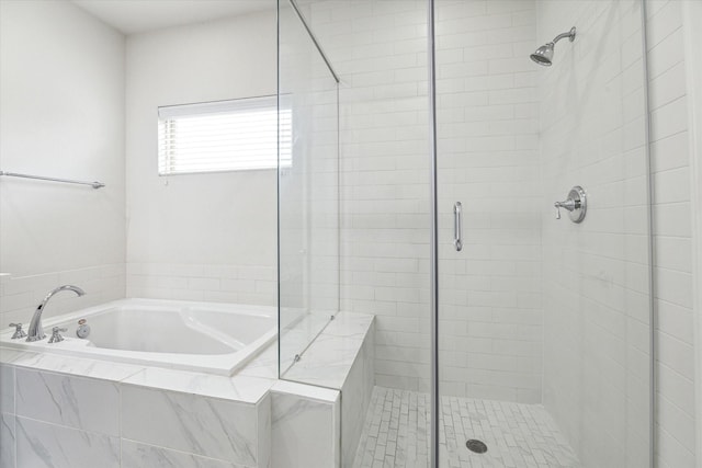 bathroom with separate shower and tub