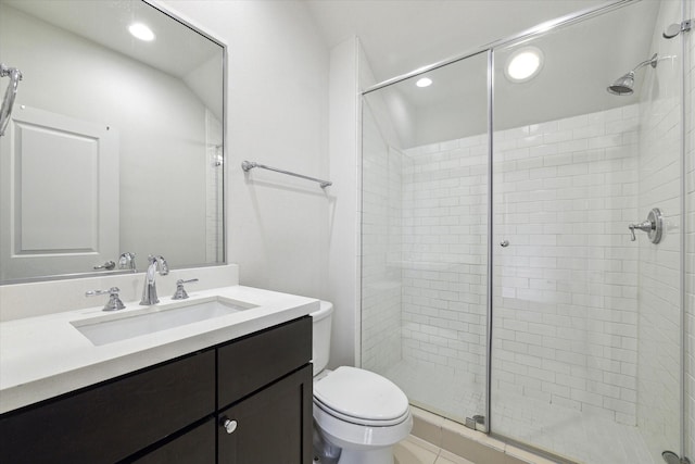 bathroom featuring tile patterned floors, a shower with door, vanity, and toilet