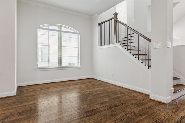 stairway with hardwood / wood-style floors, plenty of natural light, and crown molding