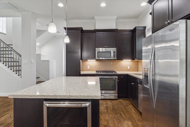 kitchen featuring pendant lighting, a kitchen island, stainless steel appliances, and dark wood-type flooring