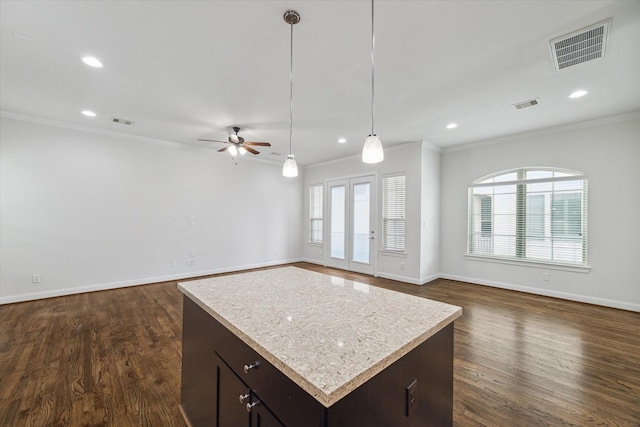 kitchen with decorative light fixtures, dark hardwood / wood-style floors, crown molding, and ceiling fan