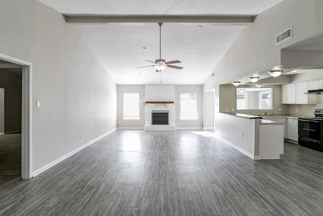 unfurnished living room with ceiling fan, dark wood-type flooring, beamed ceiling, high vaulted ceiling, and a fireplace