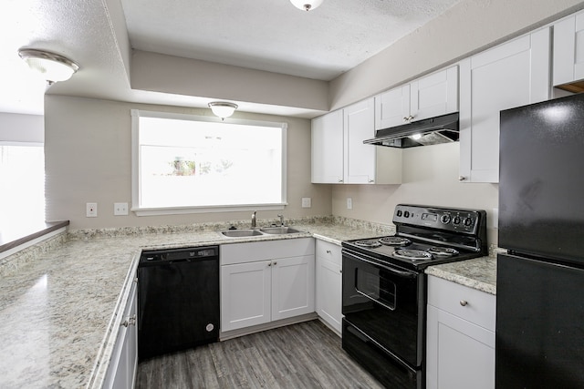 kitchen featuring white cabinetry, sink, and black appliances