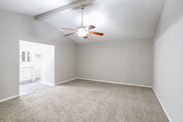 carpeted spare room with ceiling fan and lofted ceiling with beams