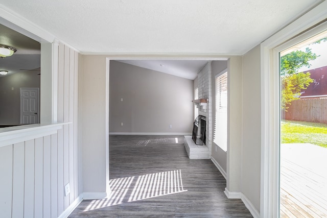 laundry room featuring a textured ceiling, a fireplace, and dark hardwood / wood-style floors