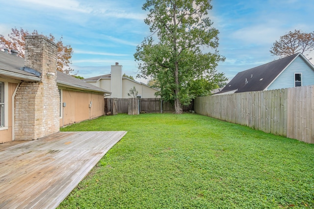 view of yard with a wooden deck