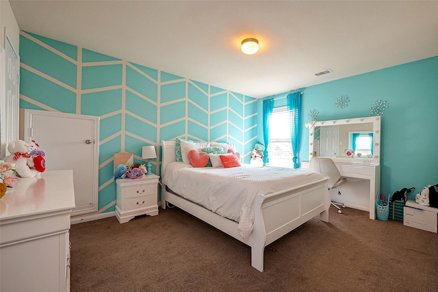 bedroom with dark colored carpet