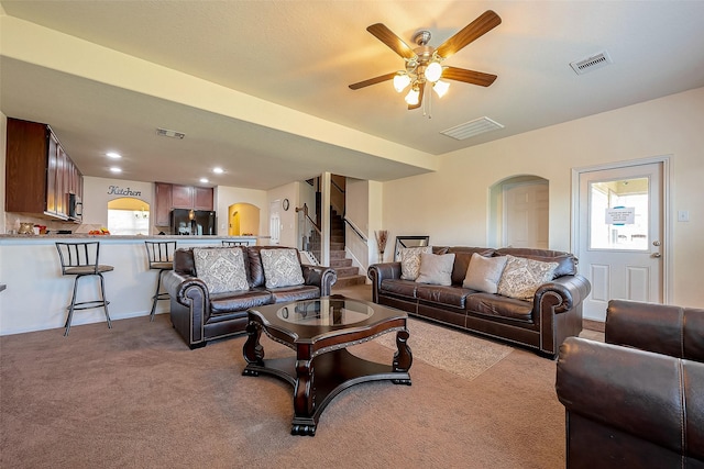 carpeted living room featuring ceiling fan